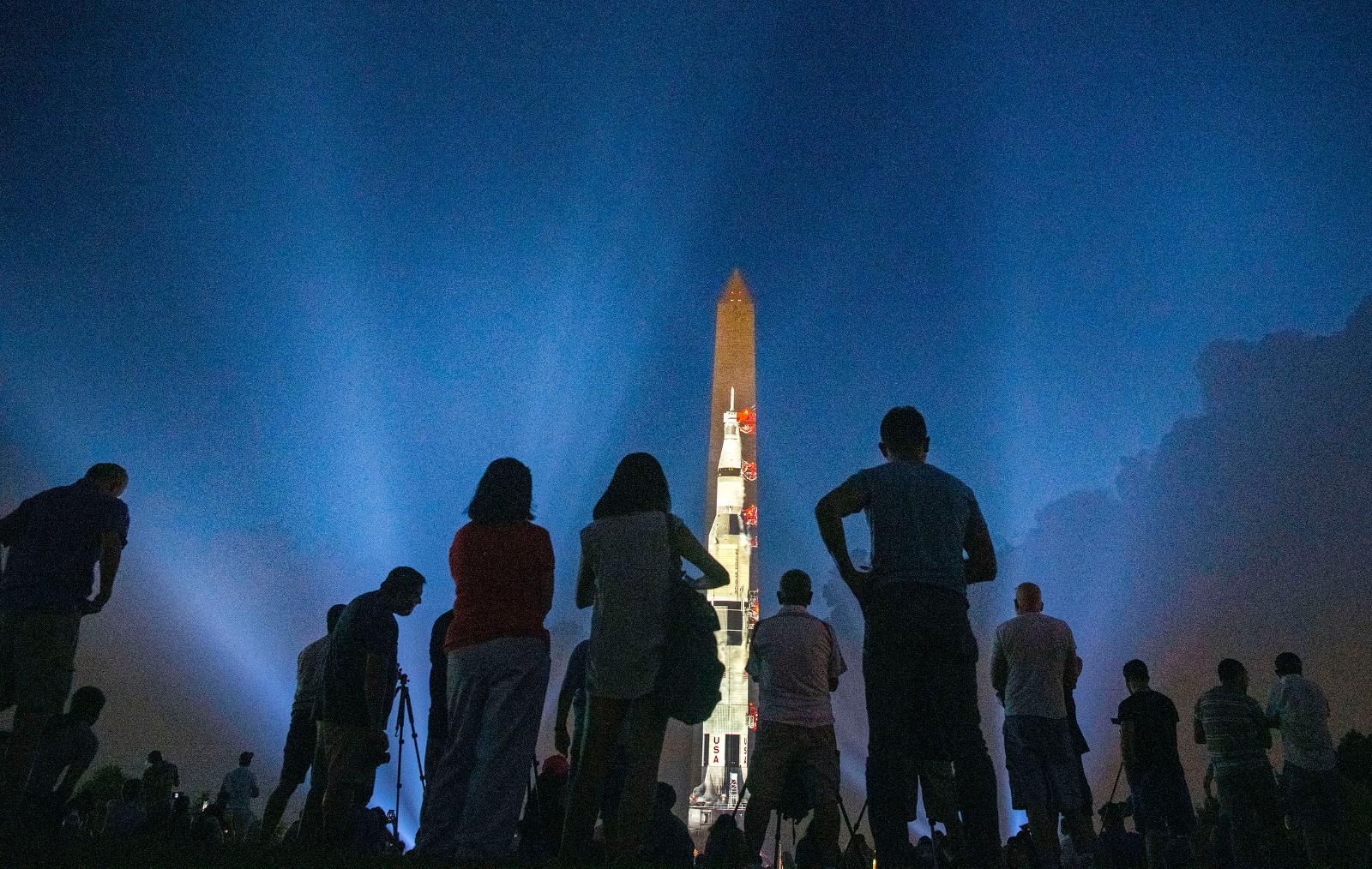 Crow watching a projection of the Apollo rockect on the Washington Manument