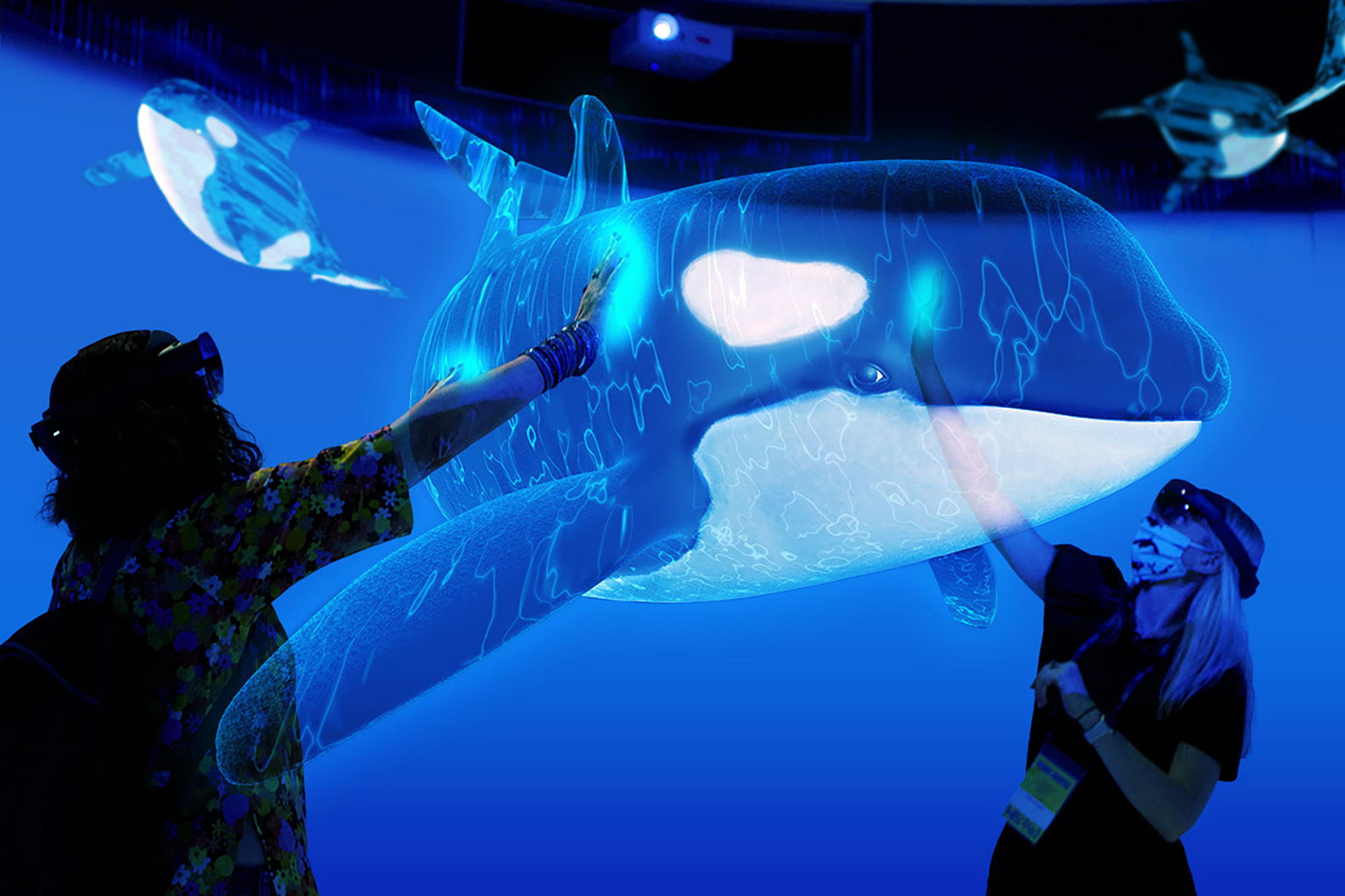 Visitors interacting with a holographic orca pod.