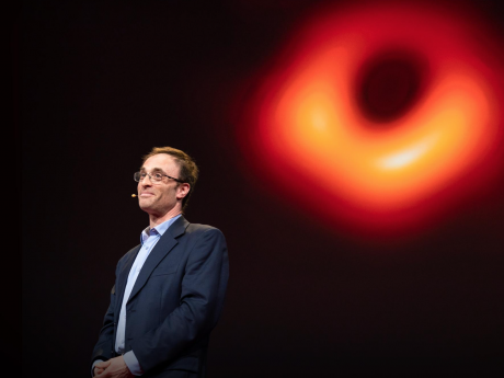 She Doleman in front of picture of black hole