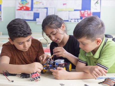 three kids working on STEM activity