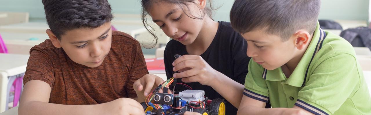 three kids working on STEM activity