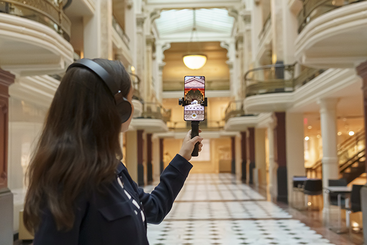 A visitor participates in an augmented reality game at the Smithsonian American Art Museum.